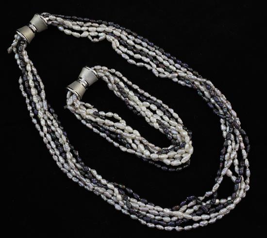 A multi strand two colour baroque seed pearl necklace with 14ct white gold clasp and matching bracelet, necklace 16in.